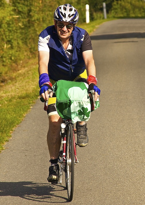 Aidan hangs his jersey on his handlebars to dry it.